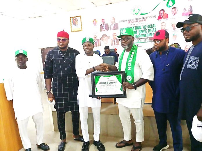 Delta State Commissioner for Youth Development, Hon. ThankGod Trakiriowei (3rd right), being decorated as grand patron of the Southern Nigeria Youth Congress (SNYC), by the Chairman, Delta State Chapter, Comrade Wiska Monday (3rd left), during the official launch of the SNYC empowerment programme held at the State Secretariat in Asaba yesterday. PIX BY BLESSING NKWOR
