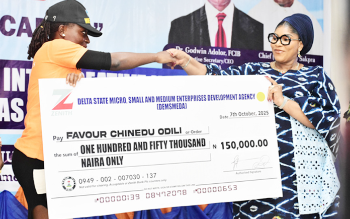 The wife of Delta State Governor and Founder, You Matter Charity Foundation Deconness. Tobore Oborevwori (right) presenting a grant to Favour Chinedu Odili during the grant disbursement to women in creative industries in the rural areas of Delta State organised by Delta State Micro, Small & Medium Enterprises Development Agency (DEMSMEDA)in collaboration with office of the 1st Lady, Delta State held at Unity Hall, Government House , Asaba yesterday.