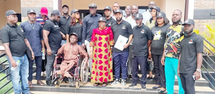 Patron of Delta Youth Transformation Movement (DYTM), Dame Nkem Okwuofu (middle) with the new executive of the group, during a courtesy visit at her residence in Asaba.